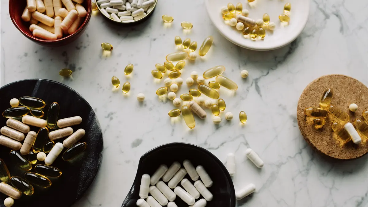 Several bowls of unlabeled supplement capsules on a marble surface, representing a side-by-side comparison